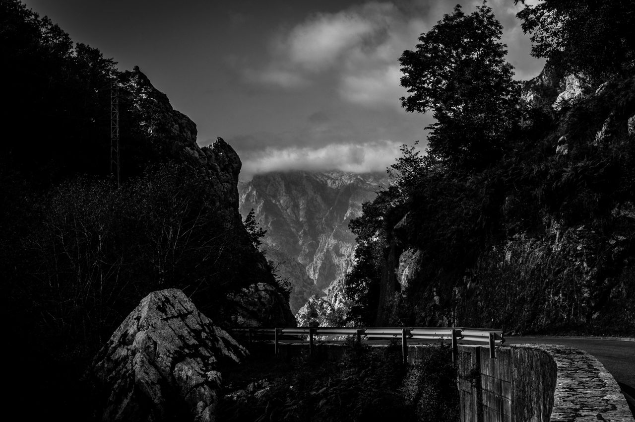 Scenic view of waterfall in forest against sky