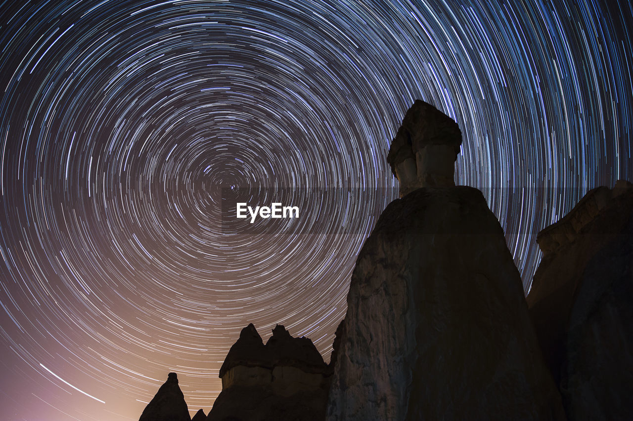 LOW ANGLE VIEW OF SILHOUETTE ROCK FORMATION AGAINST SKY