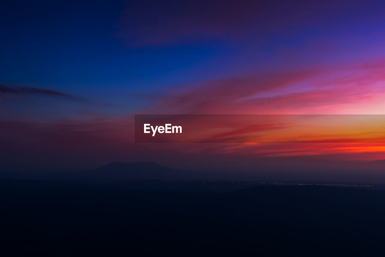 Scenic view of silhouette mountain against sky during sunset