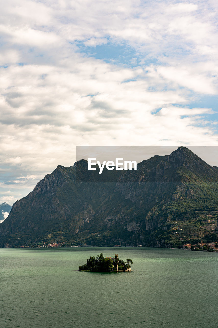 Scenic view of sea and mountains against sky