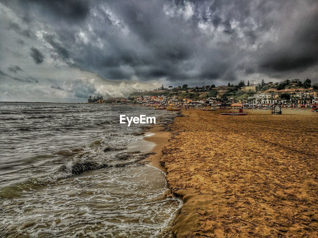 View of beach against cloudy sky