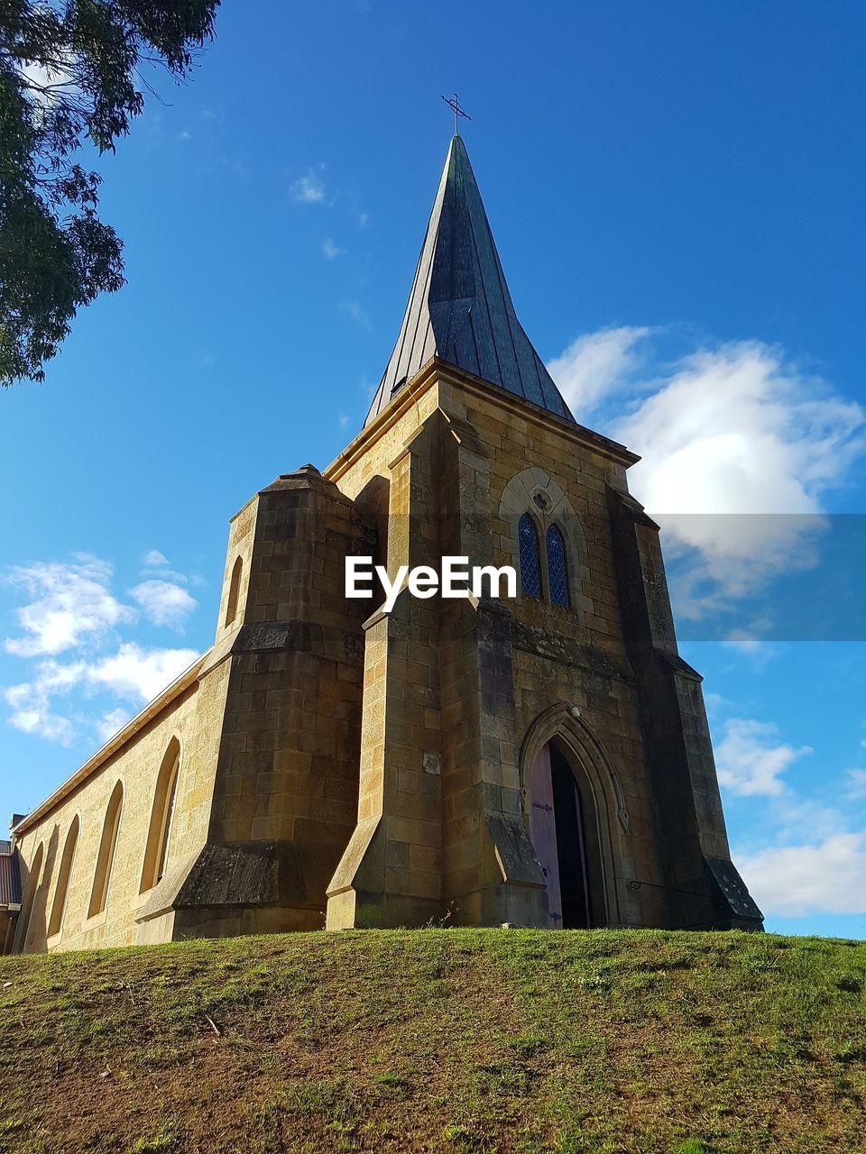 LOW ANGLE VIEW OF BUILT STRUCTURES AGAINST BLUE SKY