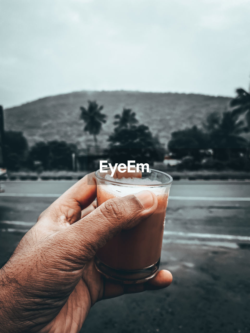 Close-up of hand holding drinking glass