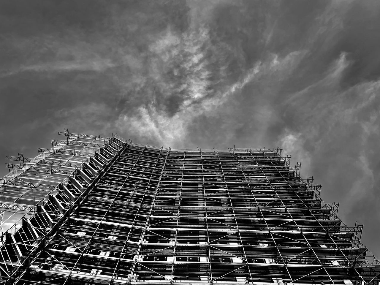 Low angle view of building under construction against sky