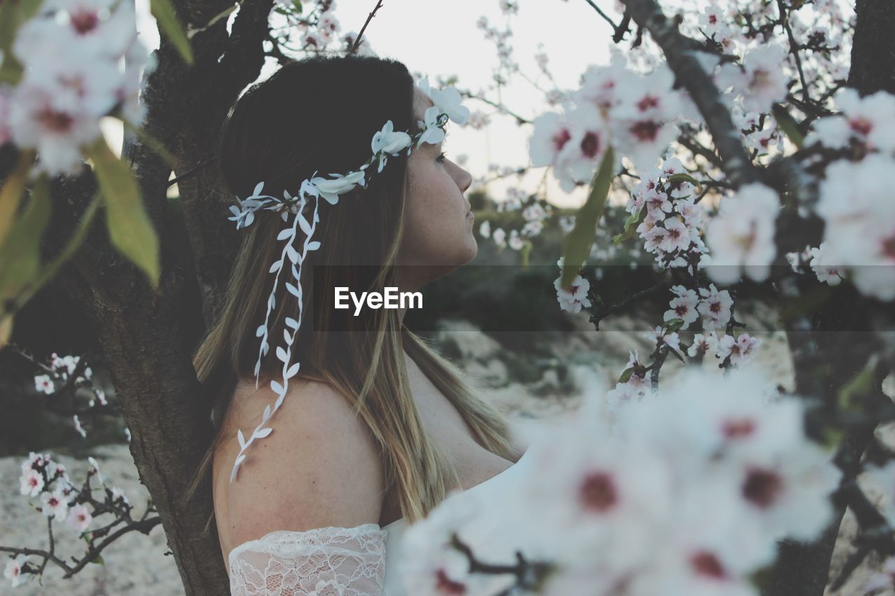 Woman by white blooming flowers