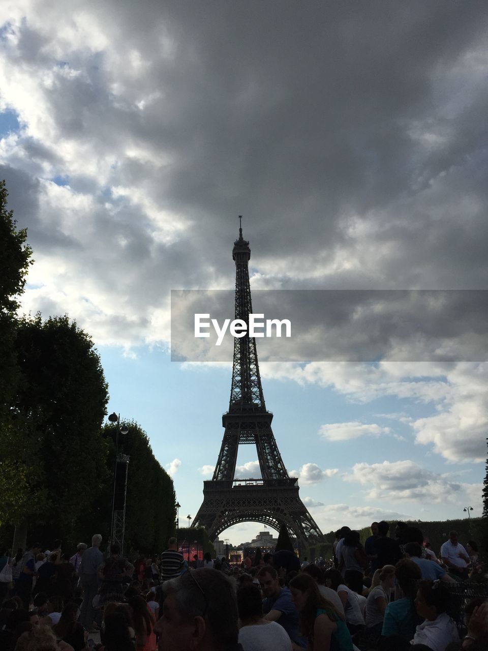 Low angle view of eiffel tower against cloudy sky