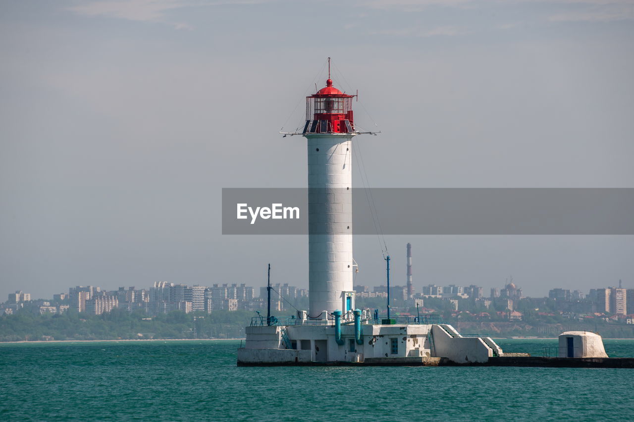 Lighthouse at the entrance to the harbor of odessa seaport, on a sunny summer day