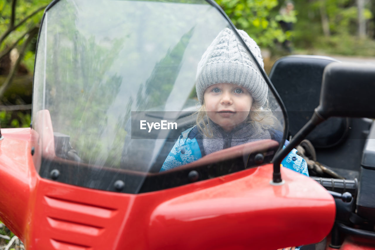 rear view of woman sitting in car