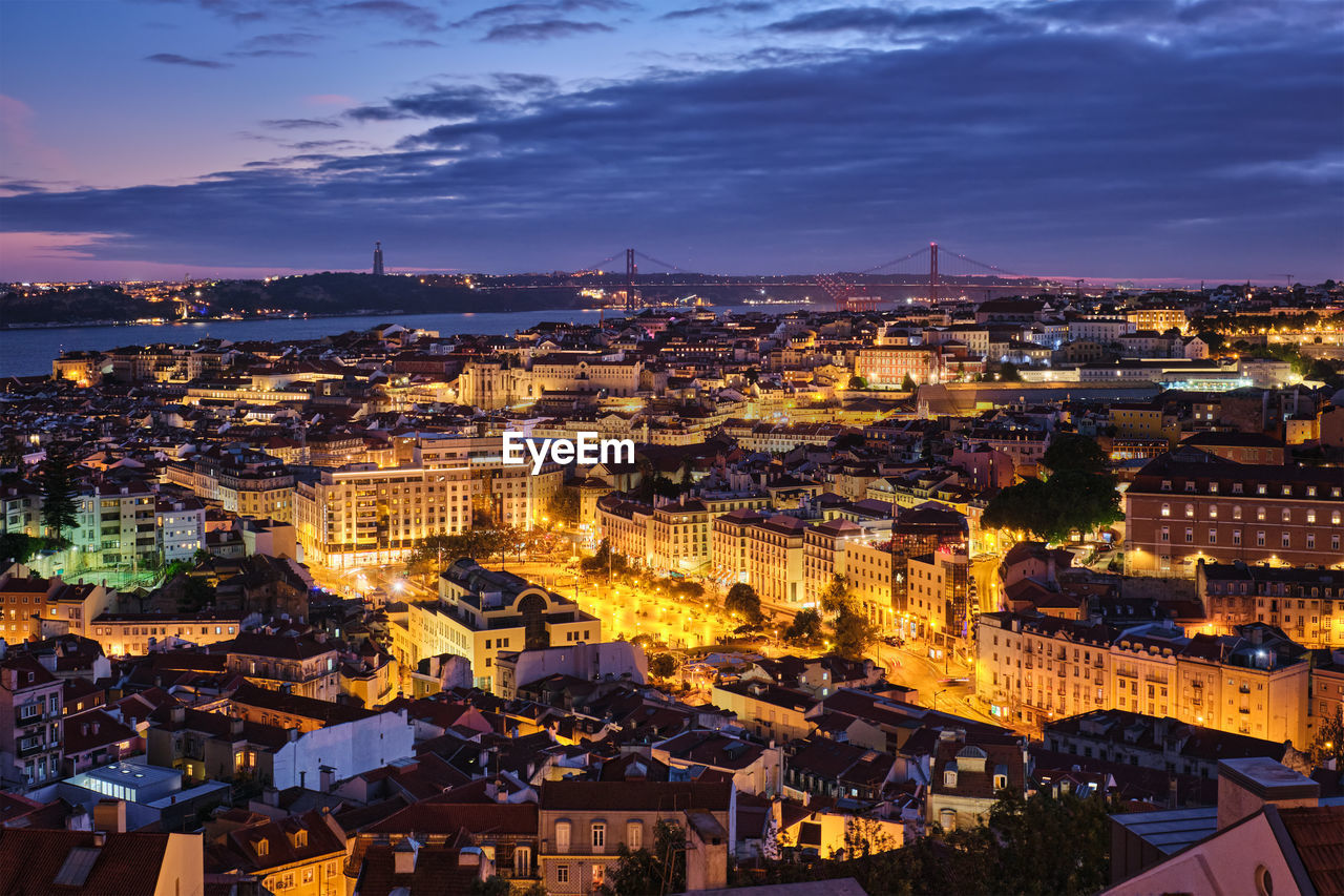 high angle view of illuminated cityscape against sky at night