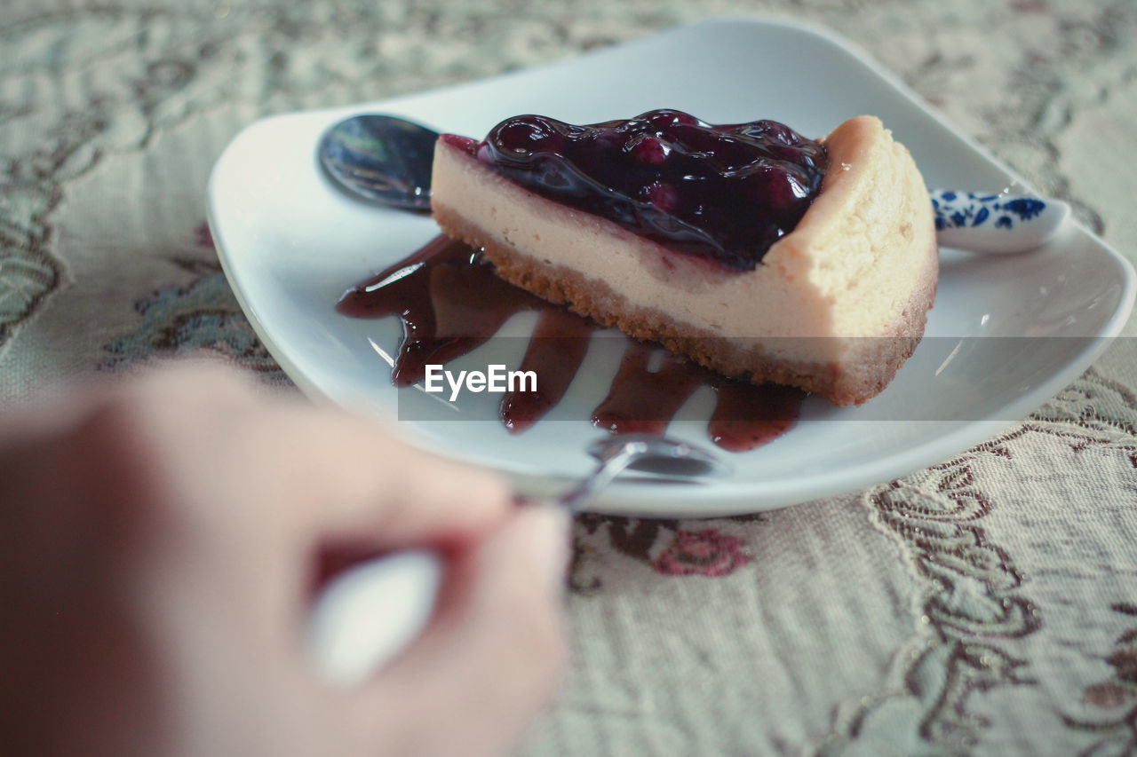 Close-up of hand holding cake