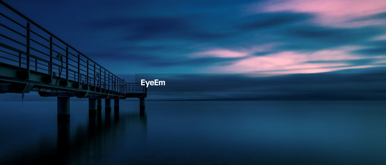 bridge over sea against sky