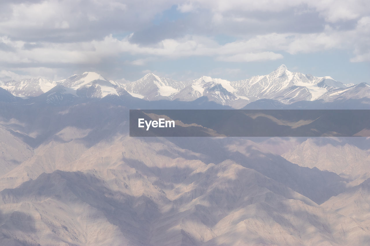 SCENIC VIEW OF SNOWCAPPED MOUNTAINS AGAINST CLOUDY SKY