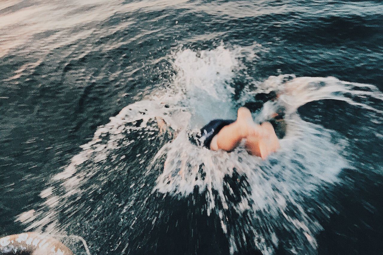 water, sea, one person, motion, high angle view, real people, waterfront, leisure activity, lifestyles, swimming, outdoors, day, nature, wave, people