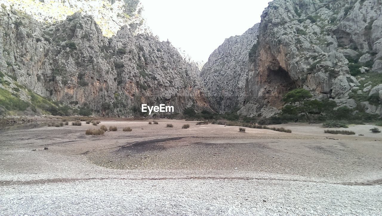 PANORAMIC VIEW OF ROCKS AND TREES ON ROCK AGAINST SKY