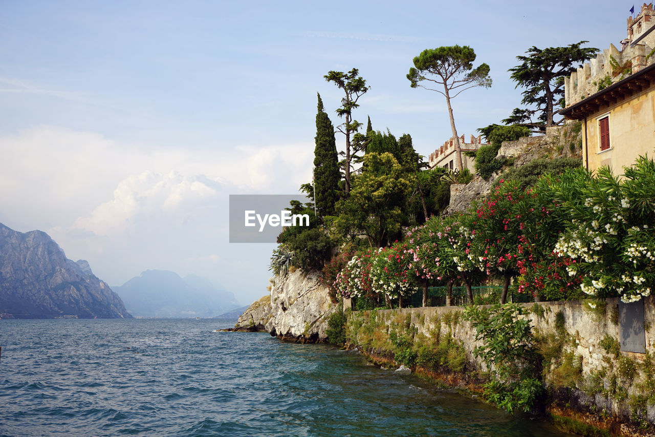 Scenic view of sea and mountains against sky