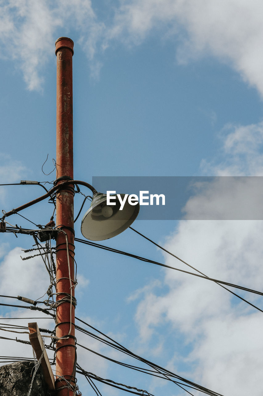 Low angle view of power lines against sky