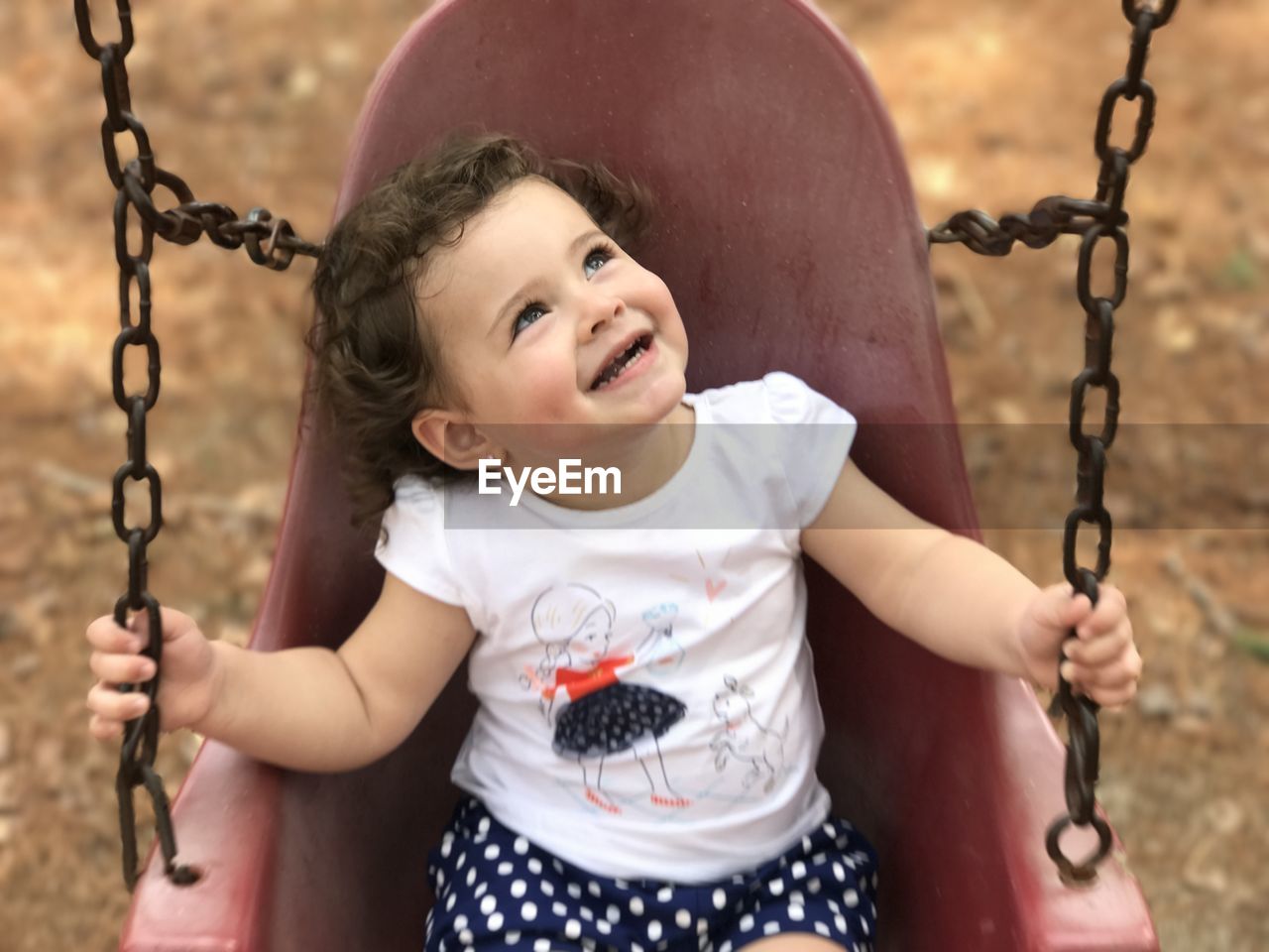 Close-up portrait of smiling girl in playground