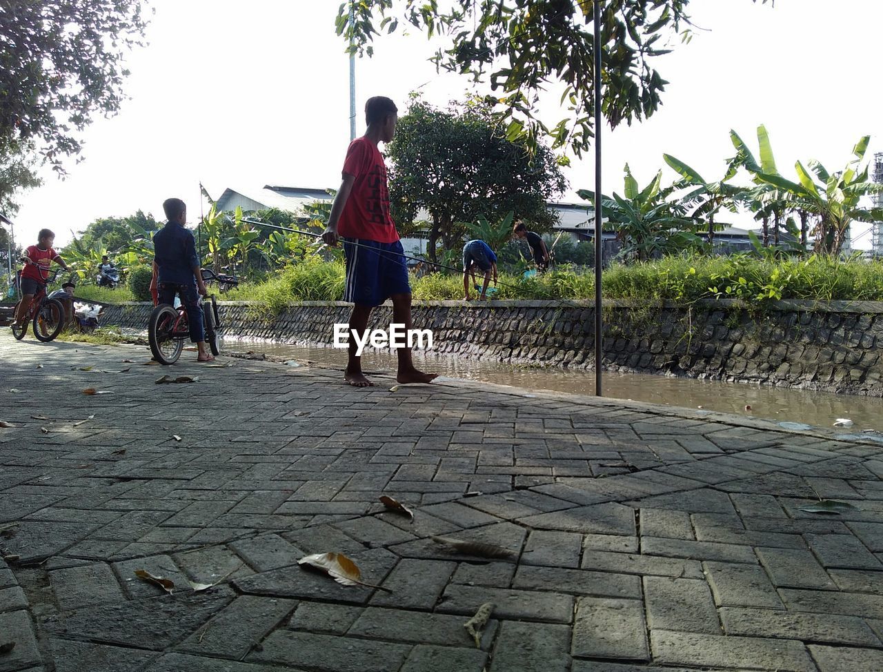 FULL LENGTH REAR VIEW OF PEOPLE WALKING ON ROAD