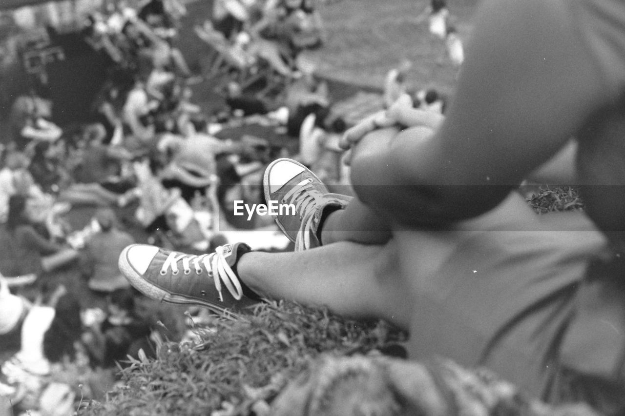 Low section of woman sitting outdoors