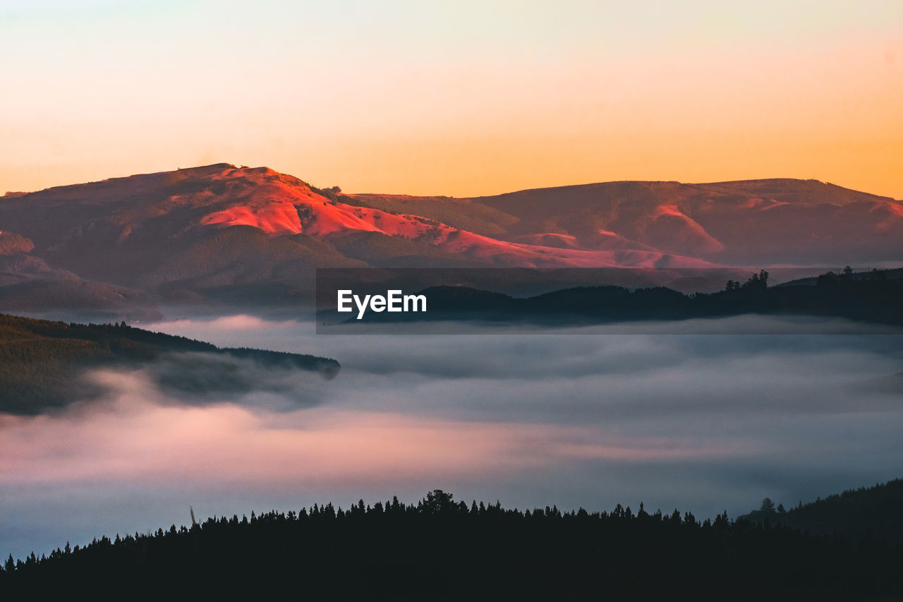 scenic view of silhouette mountain against sky during sunset