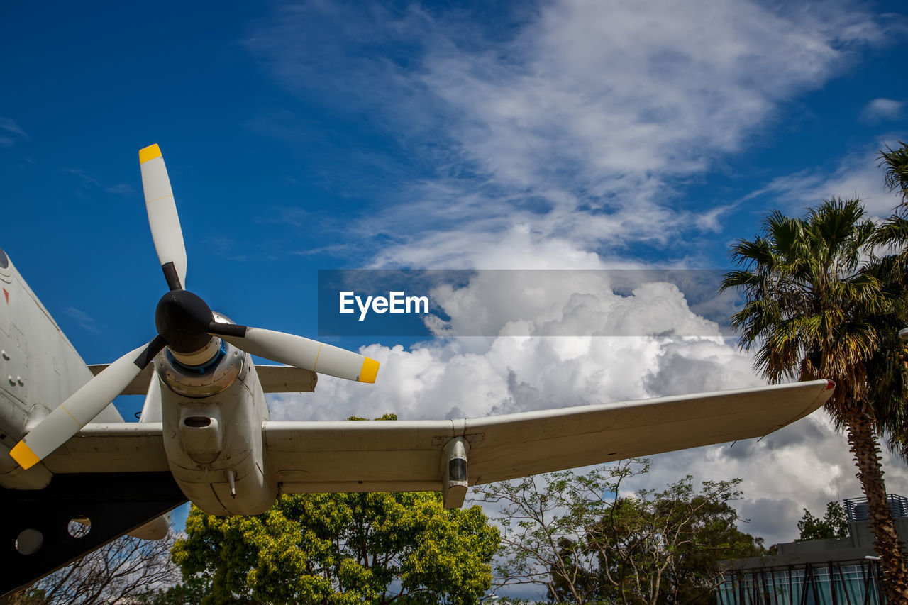 sky, cloud, air vehicle, nature, airplane, vehicle, tree, transportation, no people, flying, day, technology, aircraft, mode of transportation, outdoors, plant, blue, architecture, low angle view, aviation, military