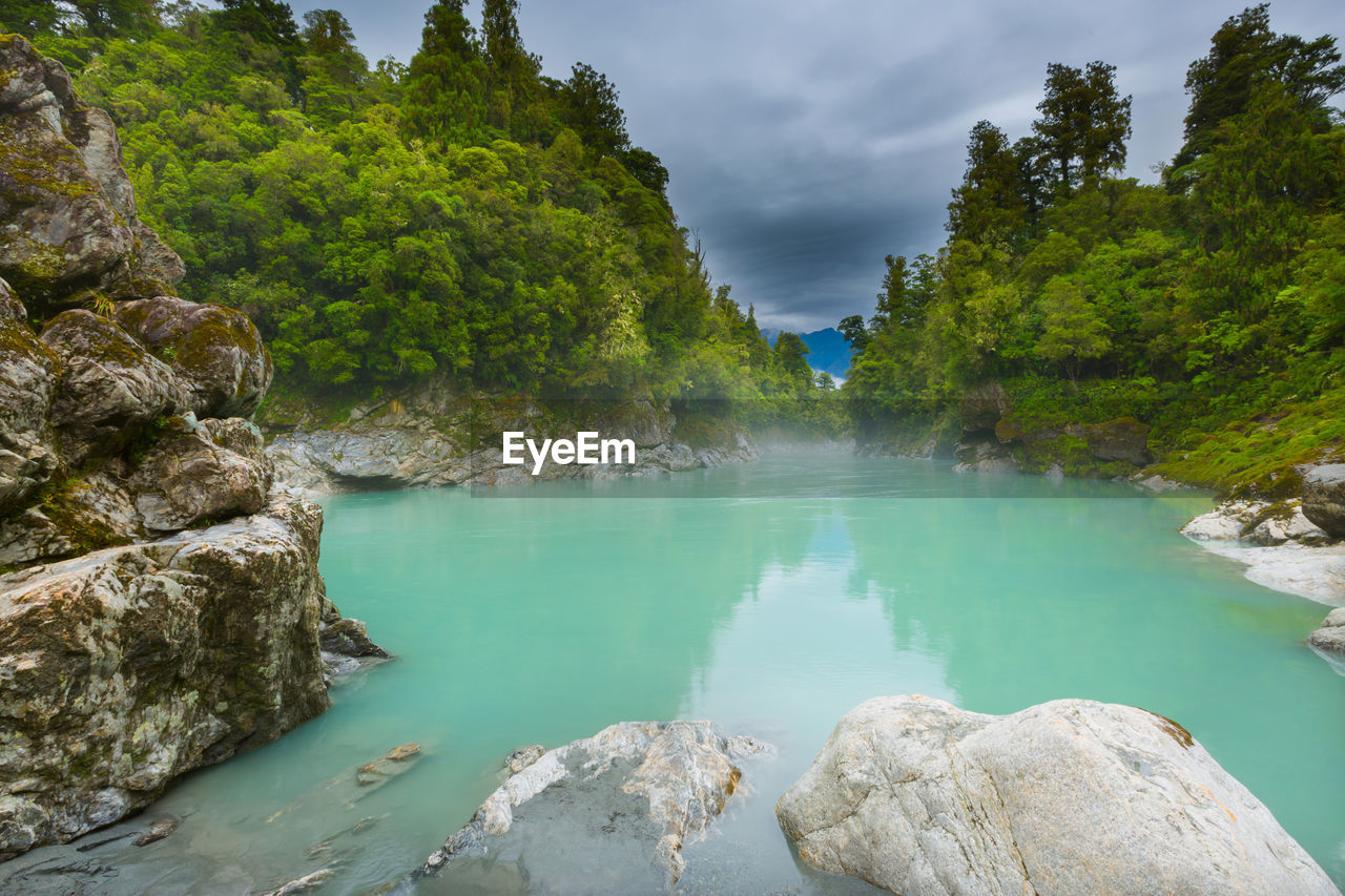 SCENIC VIEW OF LAKE AMIDST ROCKS