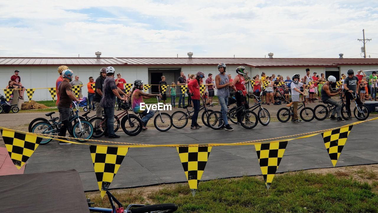 People looking at bicycle stunt event