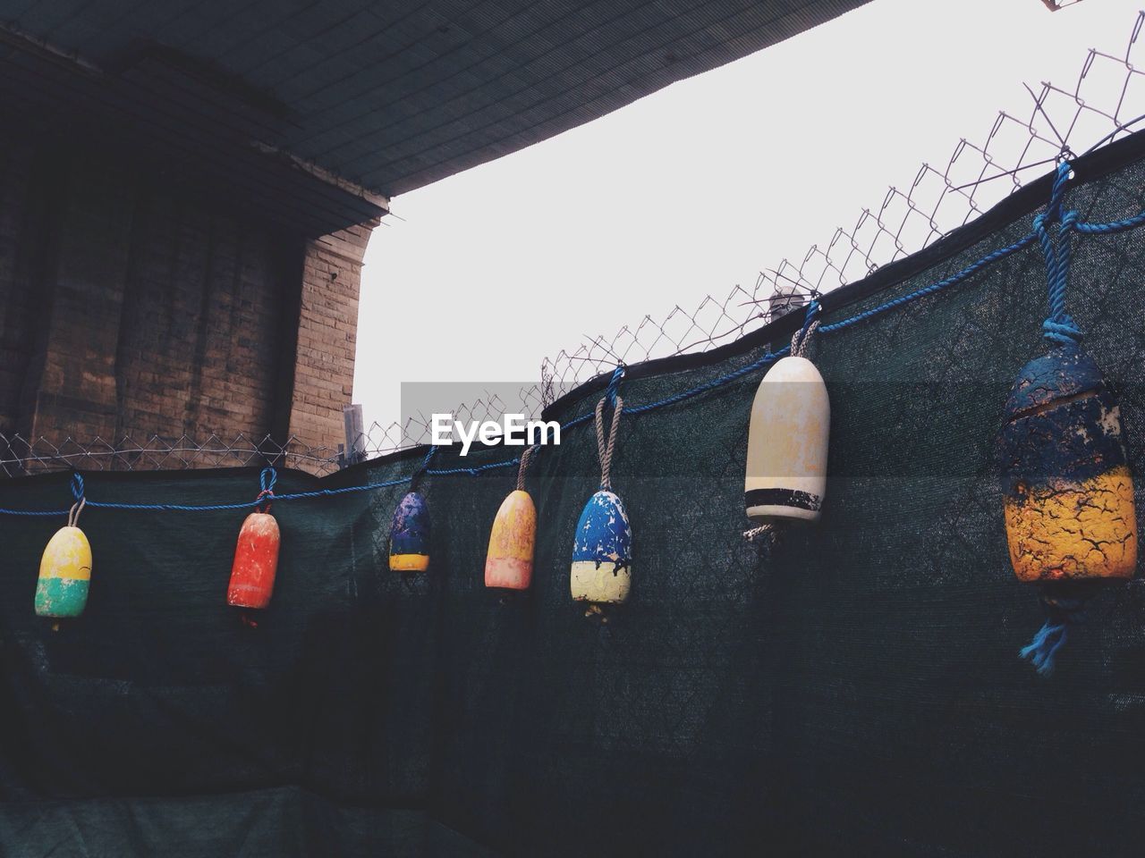 Low angle view of hanging fishing buoys