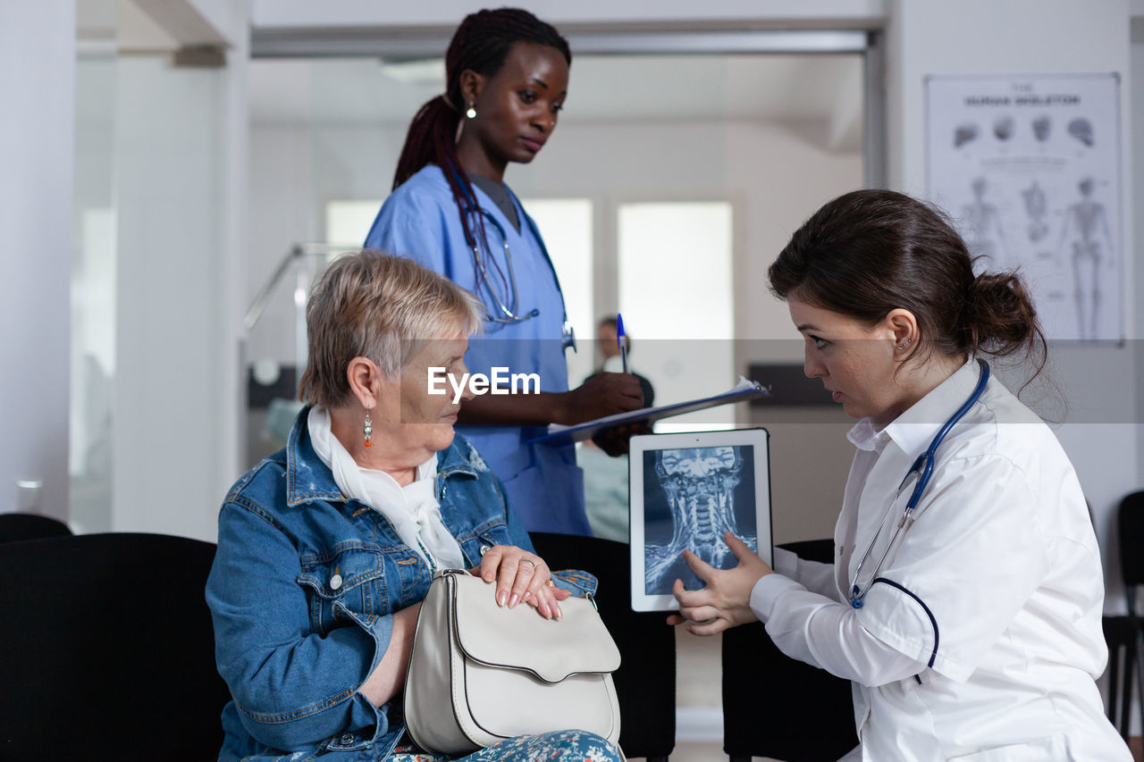 side view of doctor giving medicine to colleagues