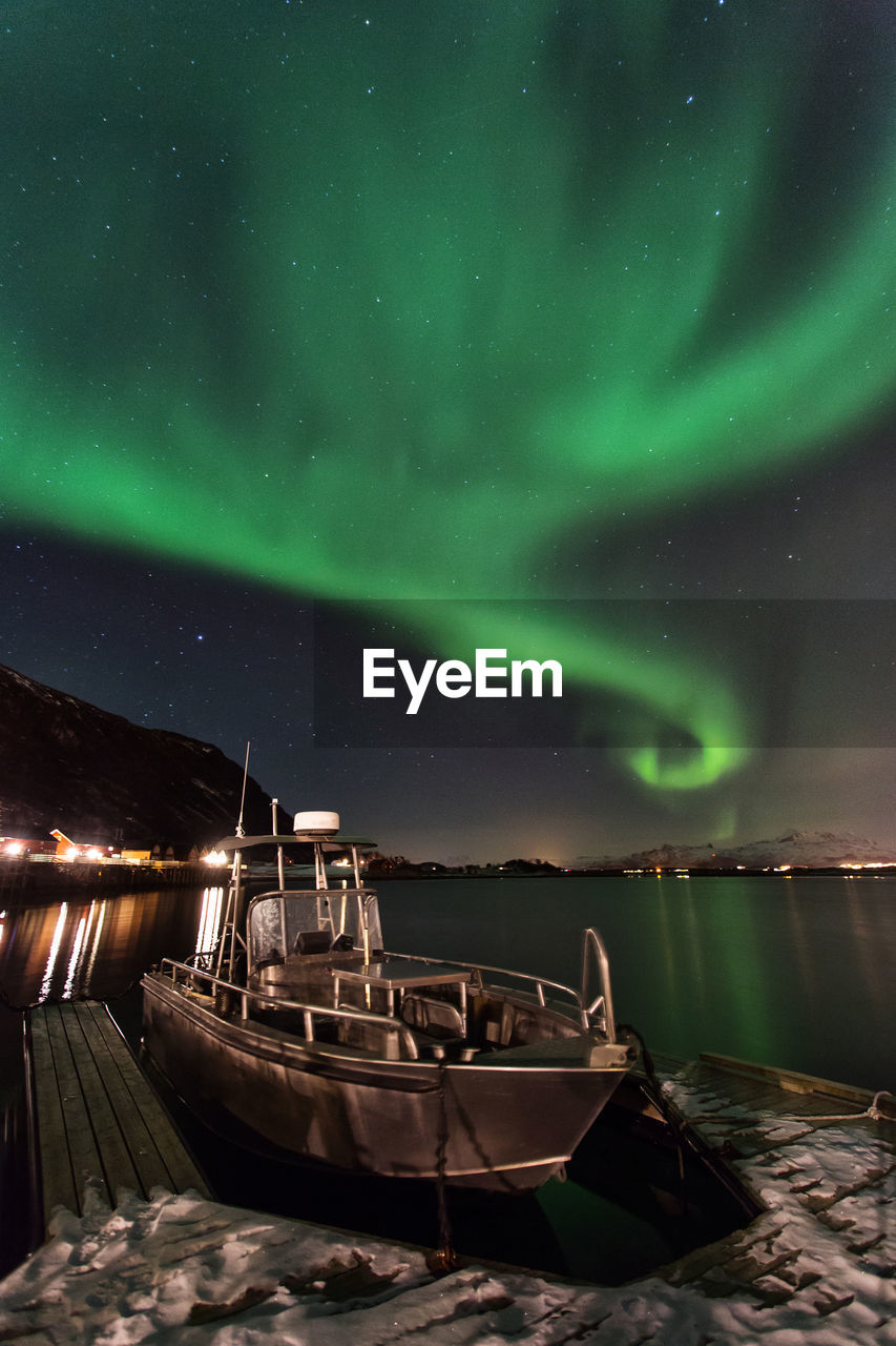 Boat moored at harbor at night