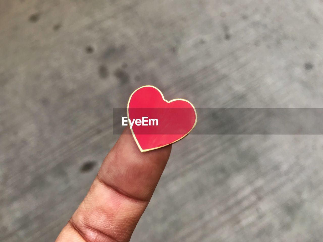 Close-up of finger holding heart shape