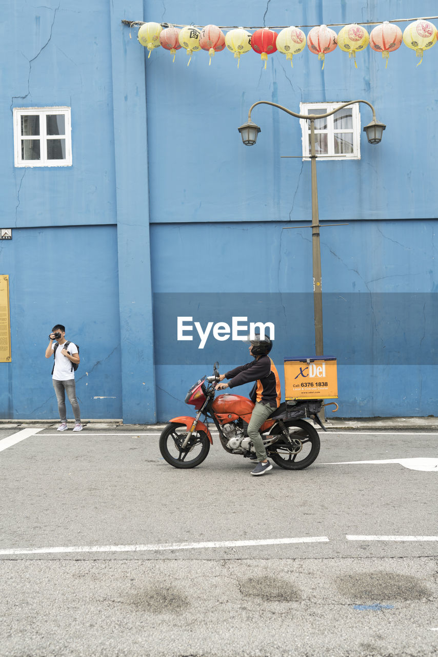 PEOPLE RIDING MOTORCYCLE ON ROAD