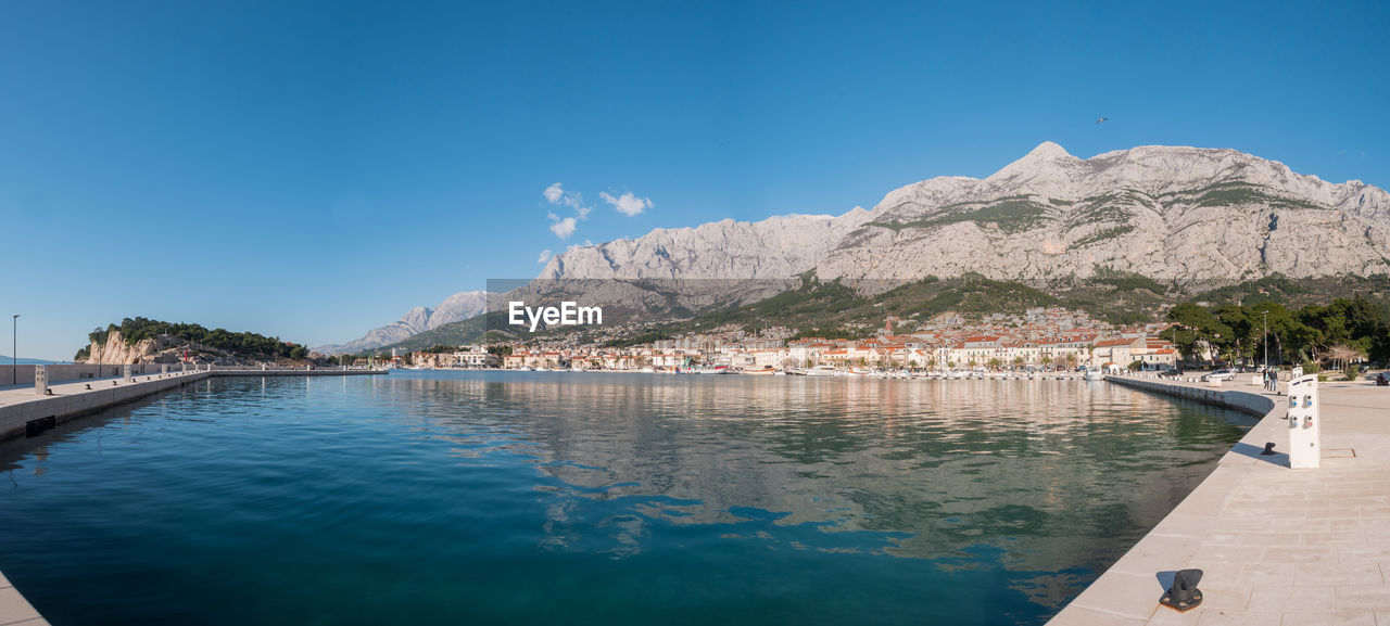 Scenic view of bay against blue sky