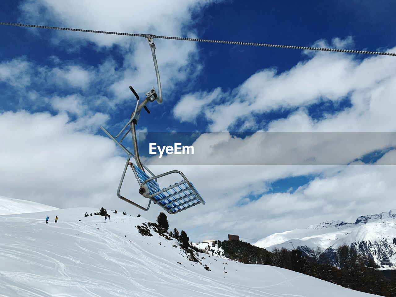 Low angle view of overhead cable car against sky during winter