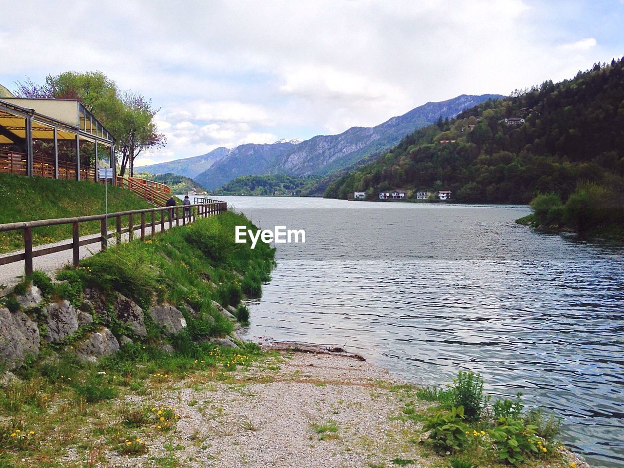 Scenic view of river against cloudy sky