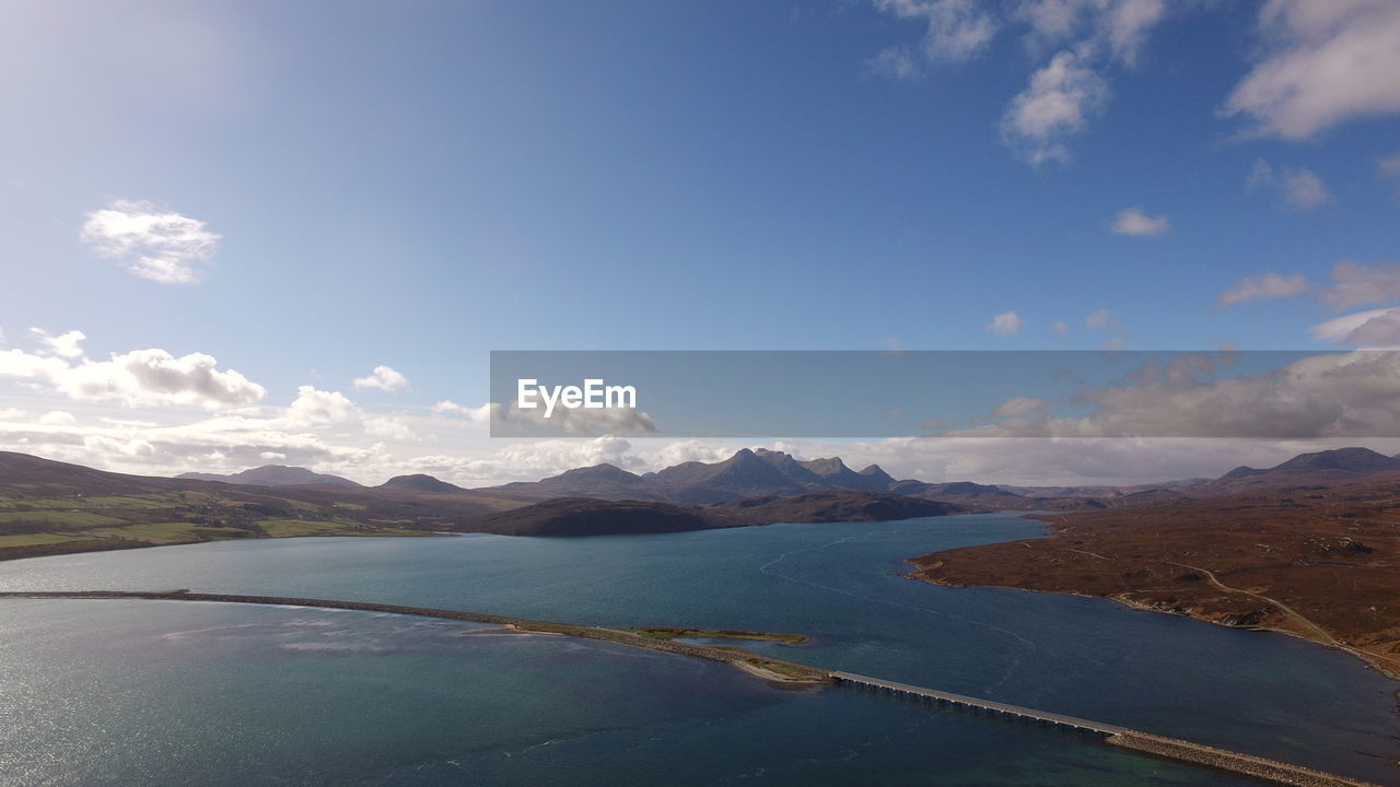 VIEW OF LAKE AGAINST CLOUDY SKY