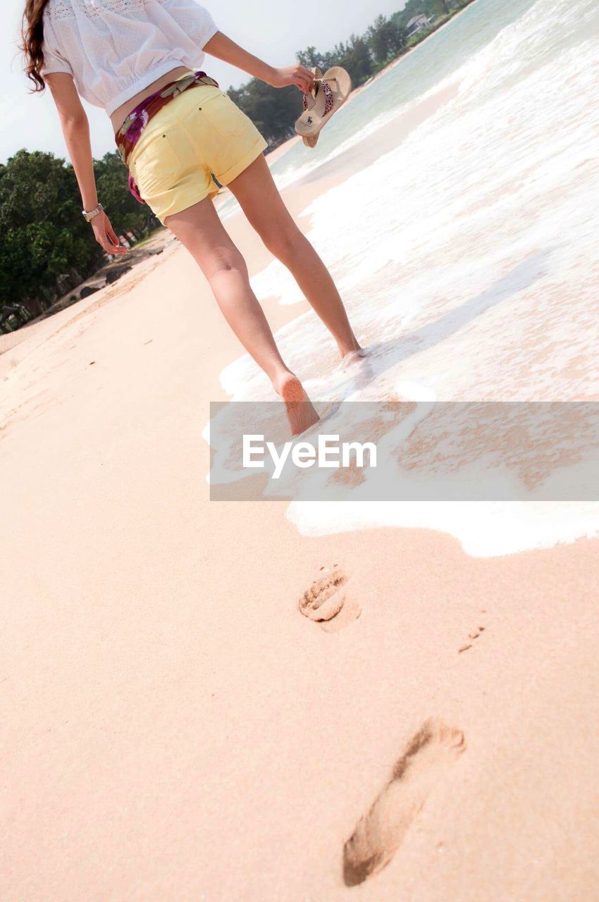 Low section of woman at beach