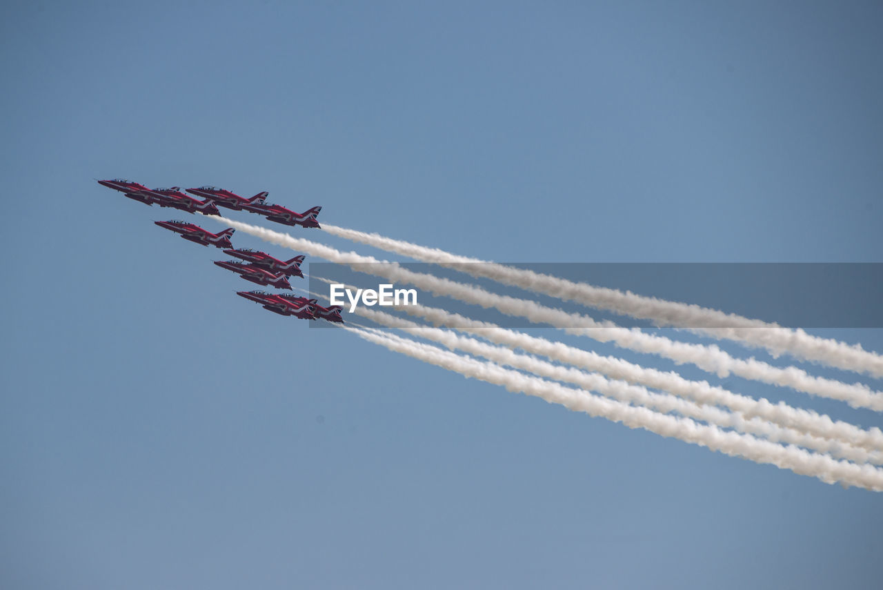 LOW ANGLE VIEW OF AIRSHOW AGAINST SKY