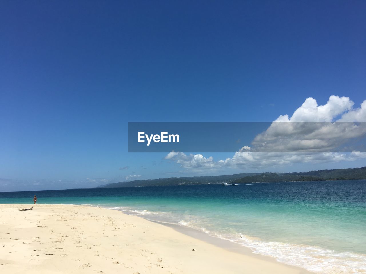 Scenic view of beach against blue sky