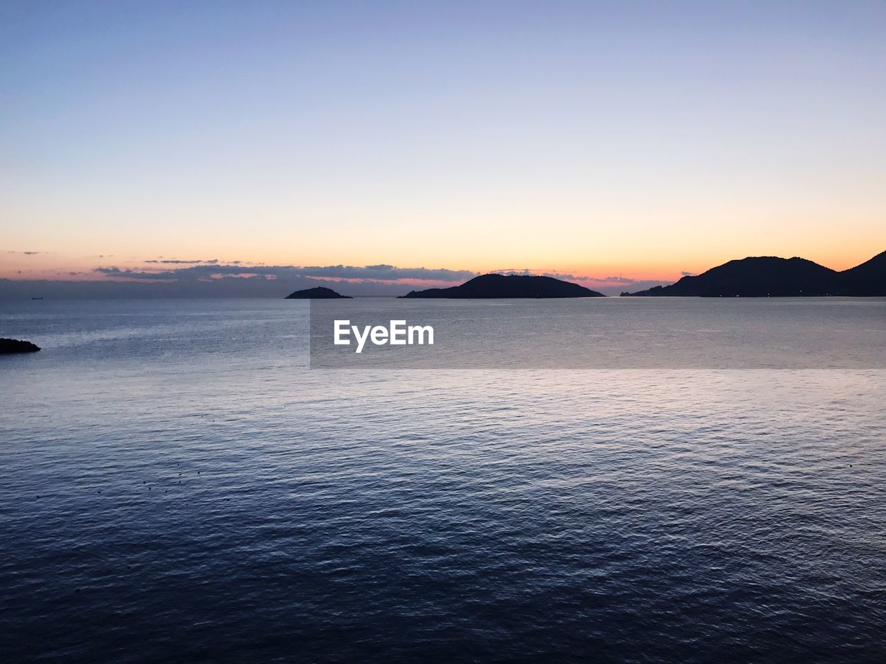 Scenic view of sea against sky at sunset