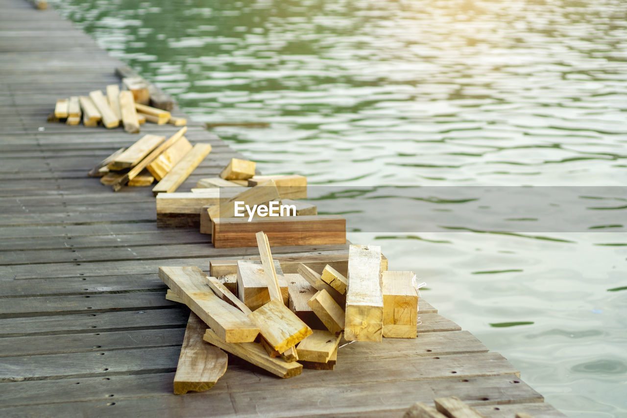 wood, water, no people, day, nature, lake, high angle view, yellow, large group of objects, outdoors, pier