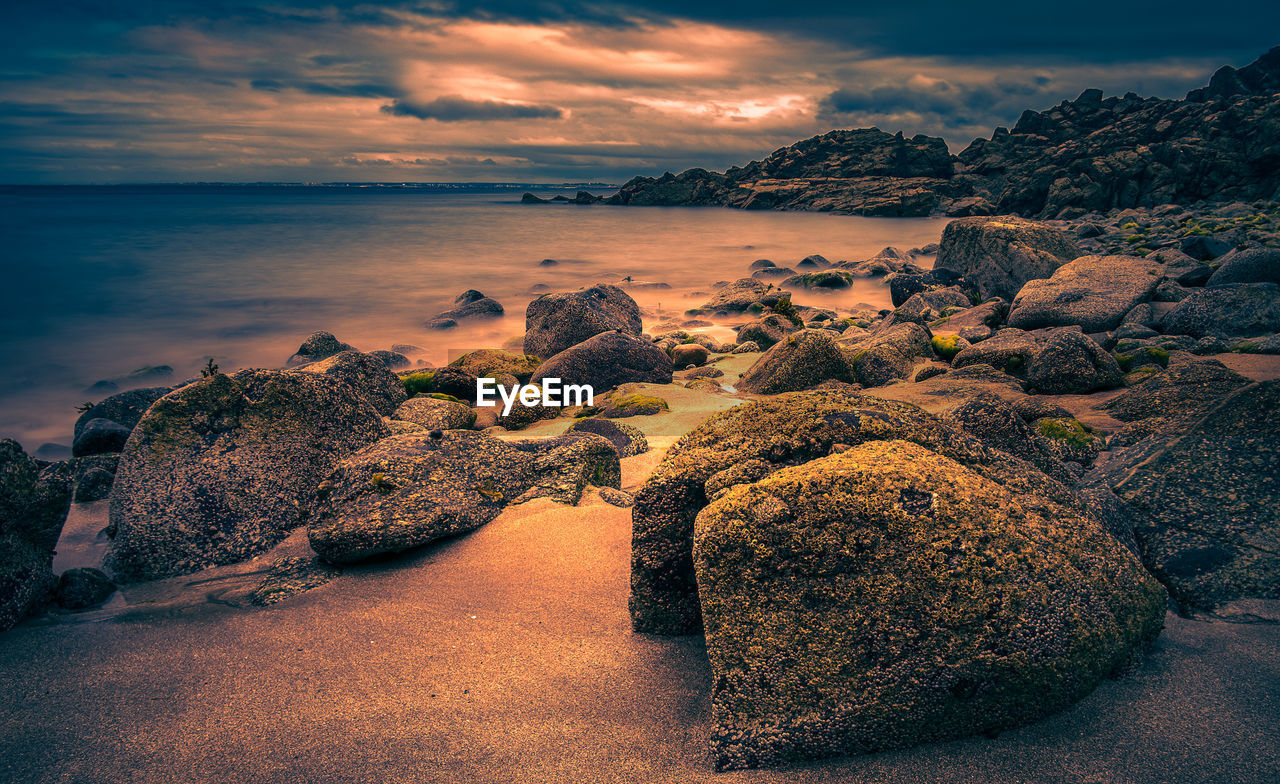 Scenic view of sea against sky at sunset