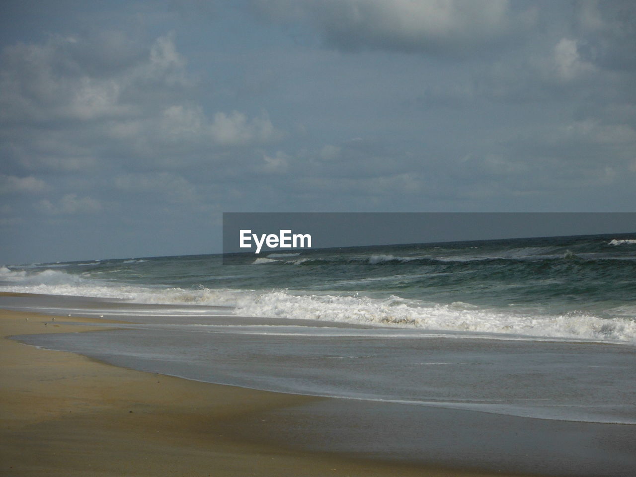 Scenic view of beach and sea against sky