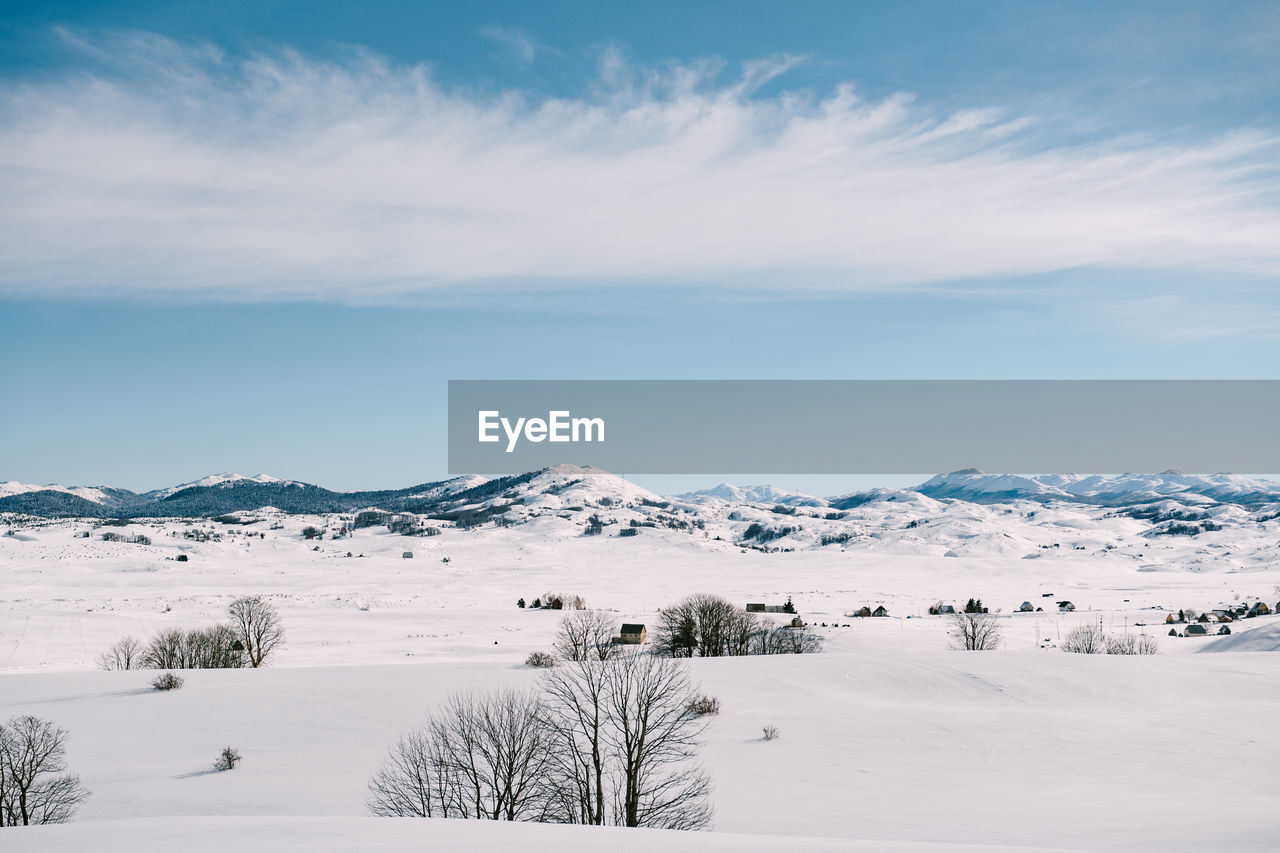 SNOW COVERED LANDSCAPE AGAINST SKY