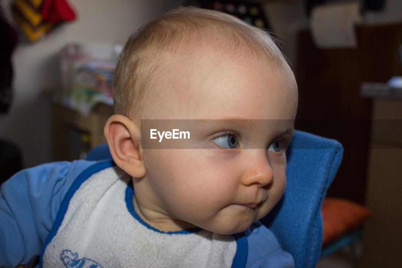 Close-up of cute baby girl at home
