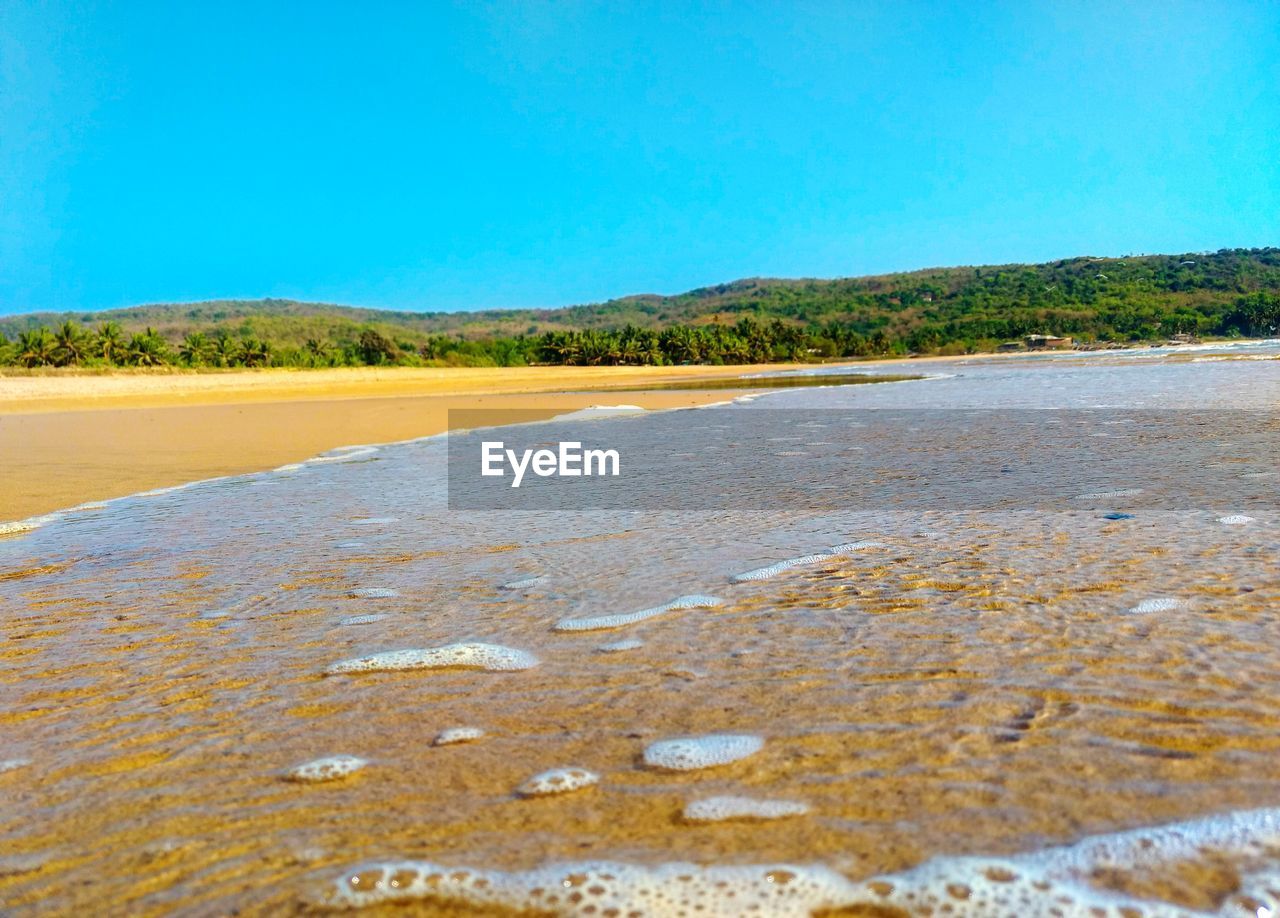 Scenic view of landscape against blue sky