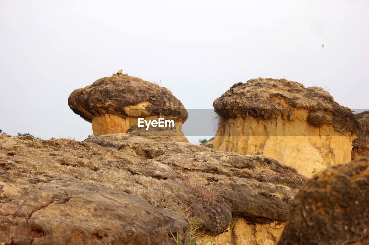 Low angle view of mushroom-shaped rock formation against clear sky