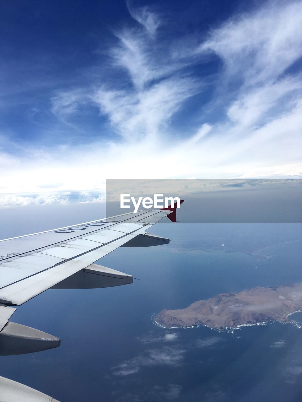 AIRPLANE FLYING OVER CLOUDS