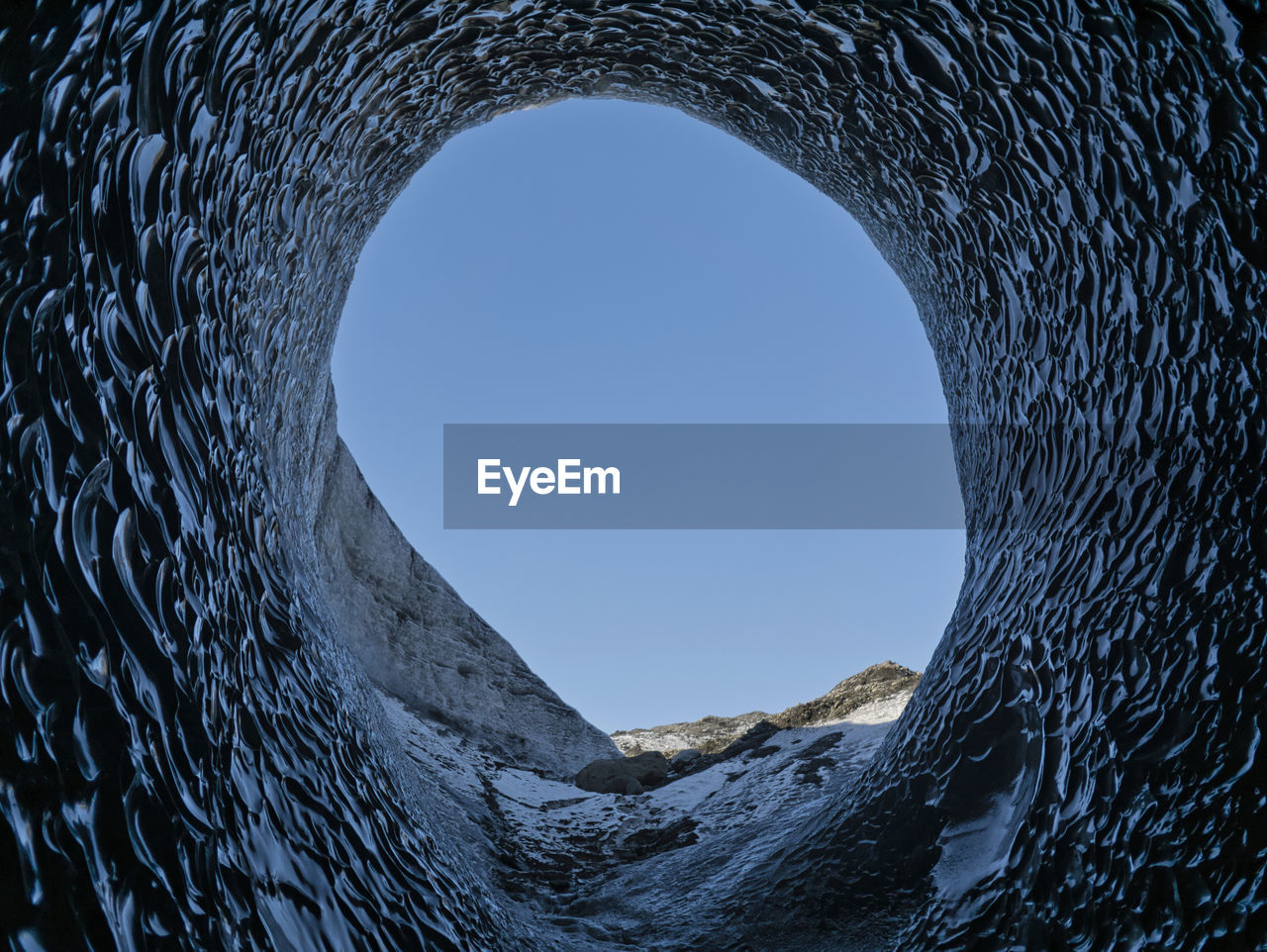 LOW ANGLE VIEW OF CLEAR BLUE SKY SEEN THROUGH HOLE