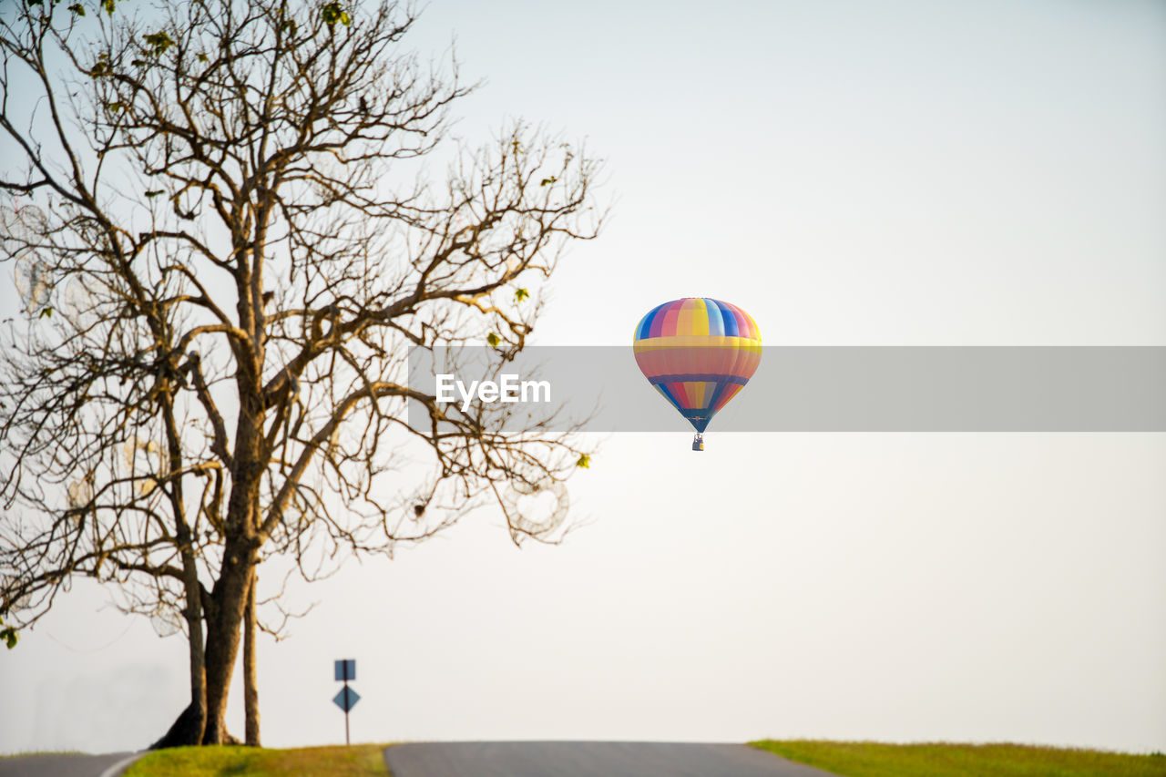 HOT AIR BALLOON FLYING AGAINST SKY